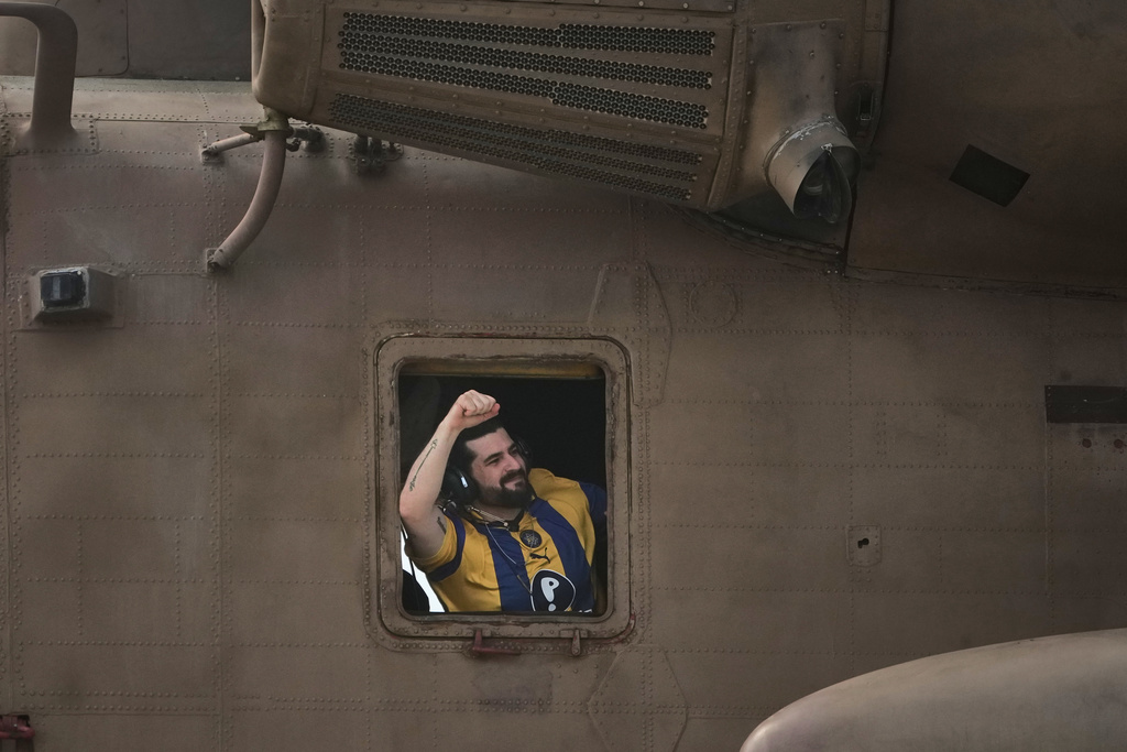 Ziv Berman, an Israeli hostage released from the Gaza Strip gestures from the window of a helicopter landing at the Sheba Medical Center in Ramat Gan, Israel, Monday, Oct. 13, 2025. (AP Photo/Leo Correa)