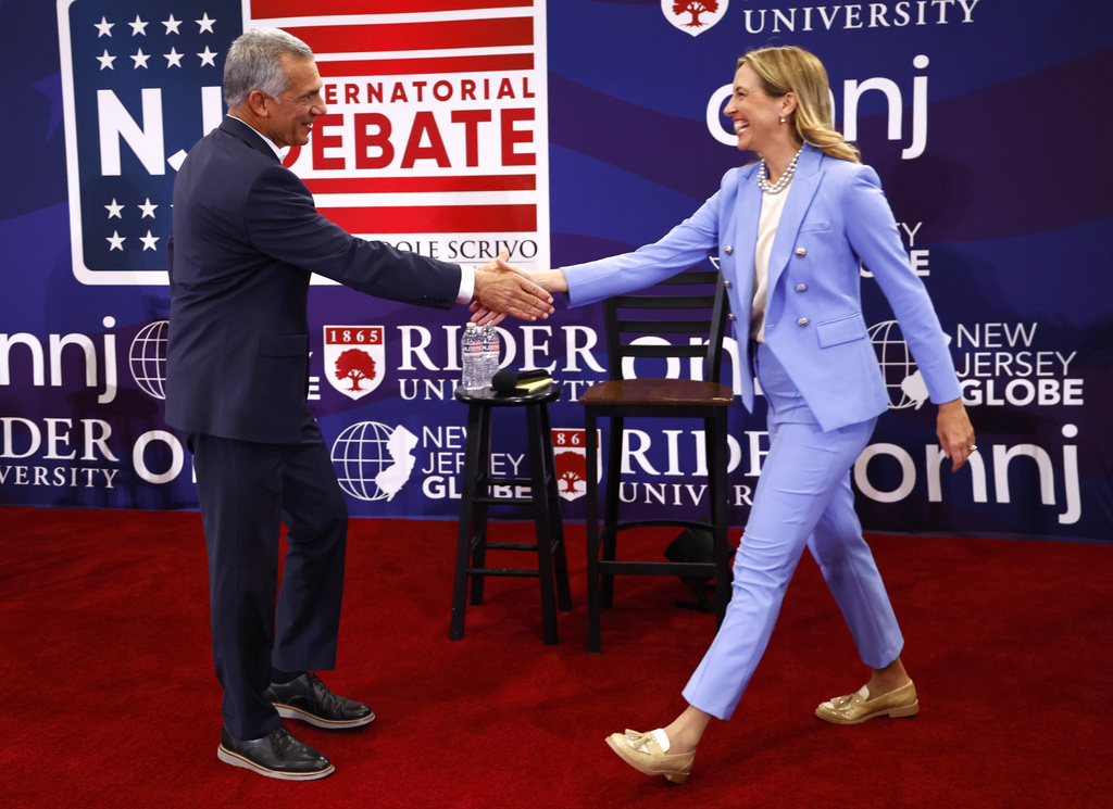 Republican candidate Jack Ciattarelli, left, shake hands with Democratic candidate for governor Mikie Sherrill, right, and before debate Sunday, Sept. 21, 2025, in Lawrenceville, N.J. (AP Photo/Noah K. Murray)