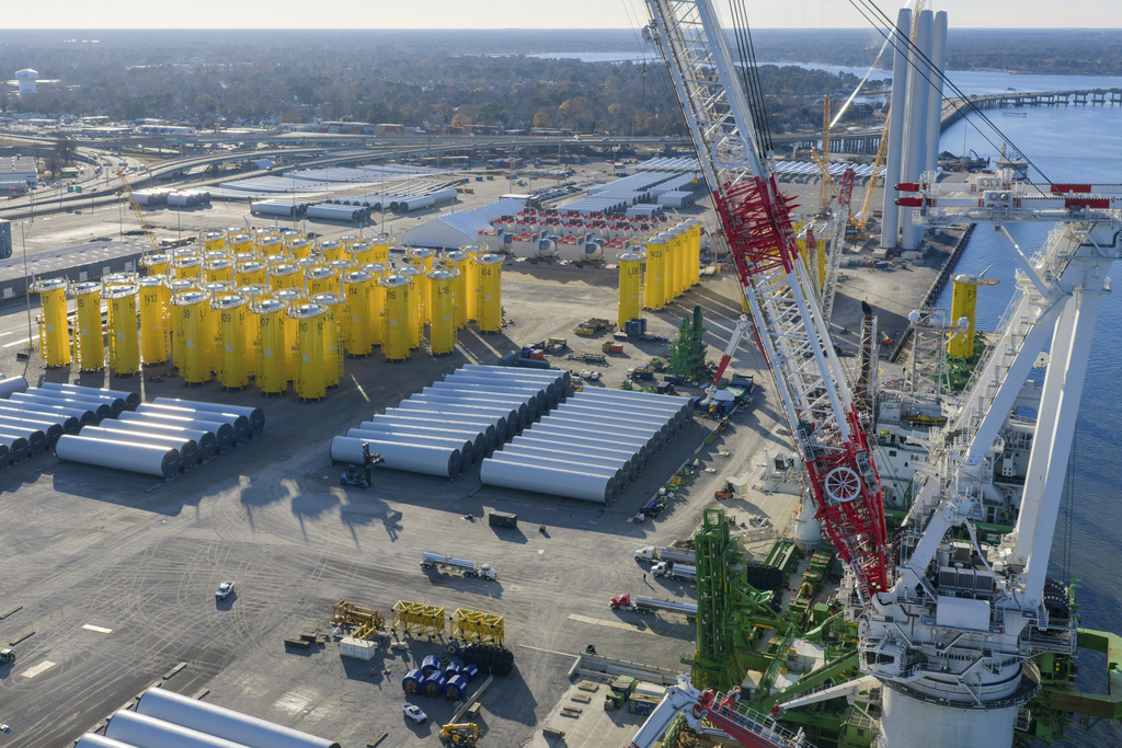 FILE - Wind turbine bases, generators and blades sit along with support ships at The Portsmouth Marine terminal that is the staging area for Dominion Energy Virginia, which is developing Coastal Virginia Offshore Wind, Dec. 22, 2025, in Portsmouth, Va. (AP Photo/Steve Helber, File)