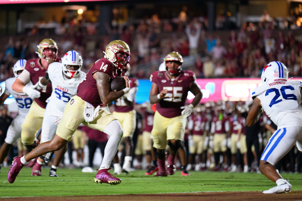Florida State quarterback Ashton Daniels (14) rushes for a touchdown during the first half of an NCAA college football game against SMU, Monday, Sept. 7, 2026, in Tallahassee, Fla. (AP Photo/Noah Lantor)