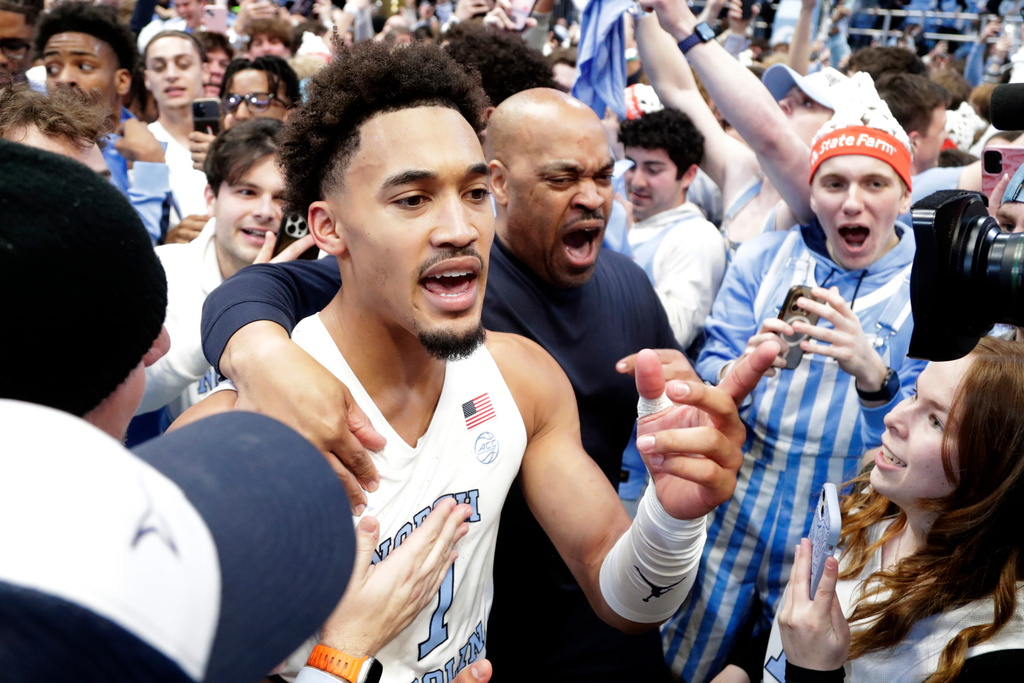 North Carolina guard Seth Trimble (7) celebrates with fans after an NCAA college basketball game against Duke, Saturday, Feb. 7, 2026, in Chapel Hill, N.C. (AP Photo/Chris Seward)