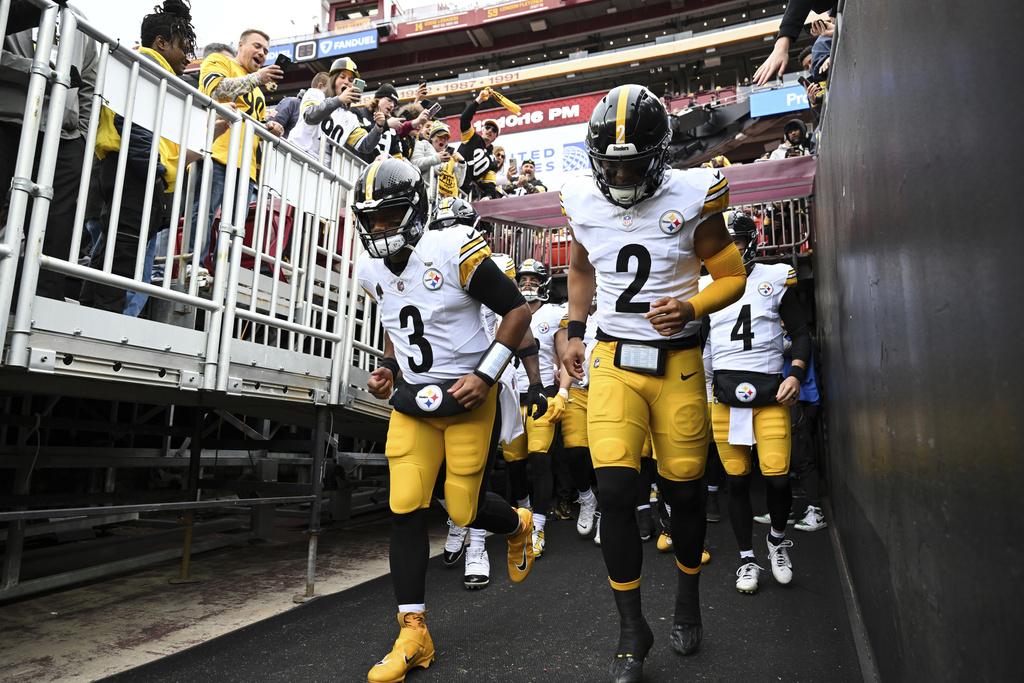 FILE - Pittsburgh Steelers quarterback Russell Wilson (3) and quarterback Justin Fields (2) lead there team onto the field before an NFL football game against the Washington Commanders, Sunday, Nov. 10, 2024, in Landover, Md. (AP Photo/Terrance Williams, file)
