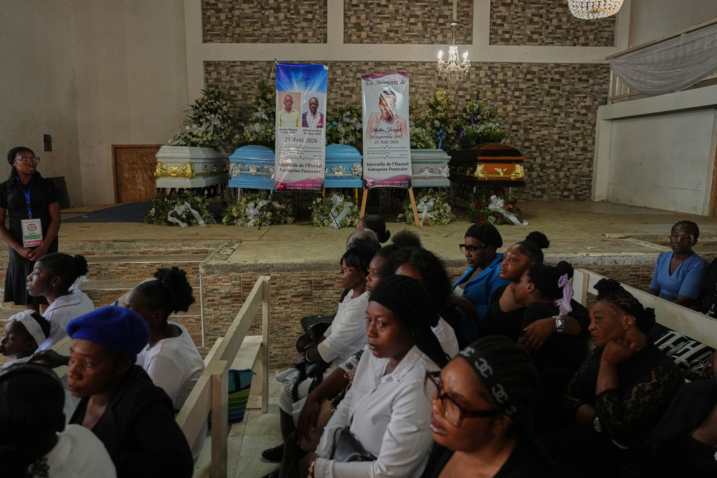 Relatives attend the funeral service for victims of a gang attack in the Kenscoff neighborhood of Port-au-Prince, Haiti, Wednesday, Sept. 2, 2026. (AP Photo/Odelyn Joseph)