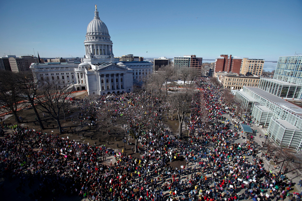 FILE - Protestors, and supporters, of Wisconsin Gov. Scott Walker's bill to eliminate collective bargaining rights for many state workers gather outside the state Capitol in Madison, Wis. on Feb. 19, 2011. (AP Photo/Andy Manis, File)