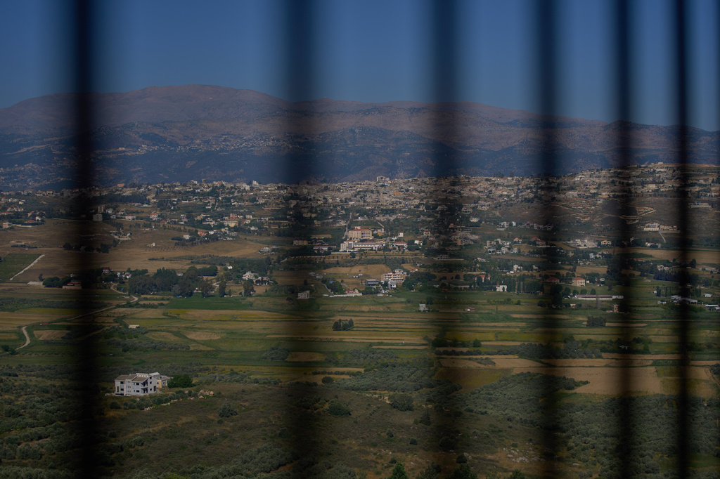 The southern town of Khiam, Lebanon, is seen through a fence near the Lebanon-Israel border, Wednesday, June 10, 2026. (AP Photo/Hassan Ammar)