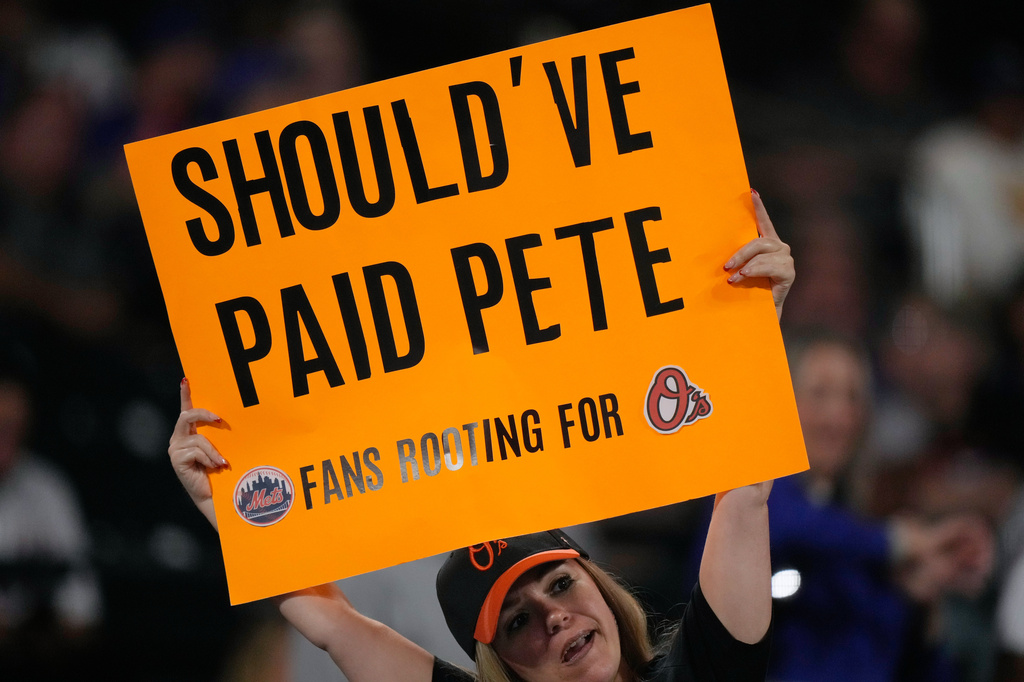A fan holds up a sign during the eleventh inning of a baseball game between the New York Mets and the Baltimore Orioles, Tuesday, Sept. 15, 2026, in New York. (AP Photo/Seth Wenig)