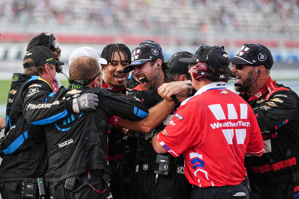 The pit crew for Shane van Gisbergen celebrates after winning a NASCAR Cup Series auto race at Charlotte Motor Speedway, Sunday, Oct. 5, 2025, in Concord, N.C. (AP Photo/Matt Kelley)