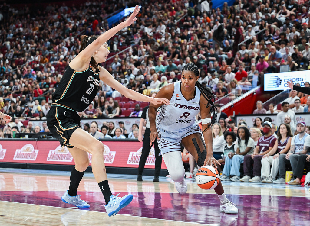 Toronto Tempo's Nyara Sabally (8) is guarded by New York Liberty's Han Xu, left, as she drives to the net during the first half of a WNBA basketball game in Montreal, Sunday, July 12, 2026. (Graham Hughes/The Canadian Press via AP)