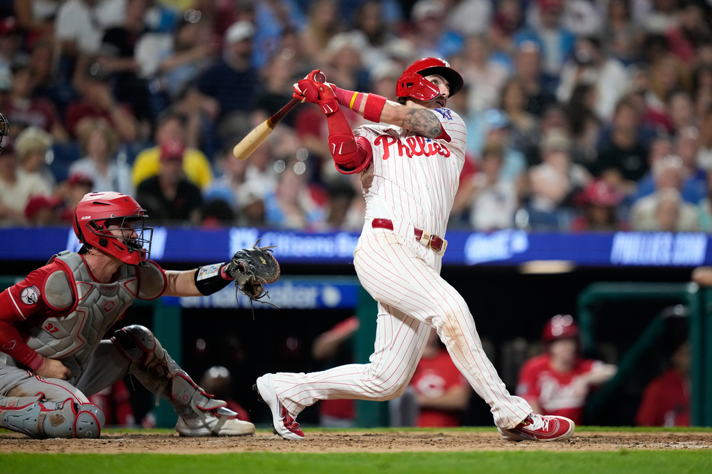 Philadelphia Phillies' Bryson Stott follows through after hitting a two-run home run against Cincinnati Reds pitcher Graham Ashcraft during the eighth inning of a baseball game Monday, May 18, 2026, in Philadelphia. (AP Photo/Matt Slocum)