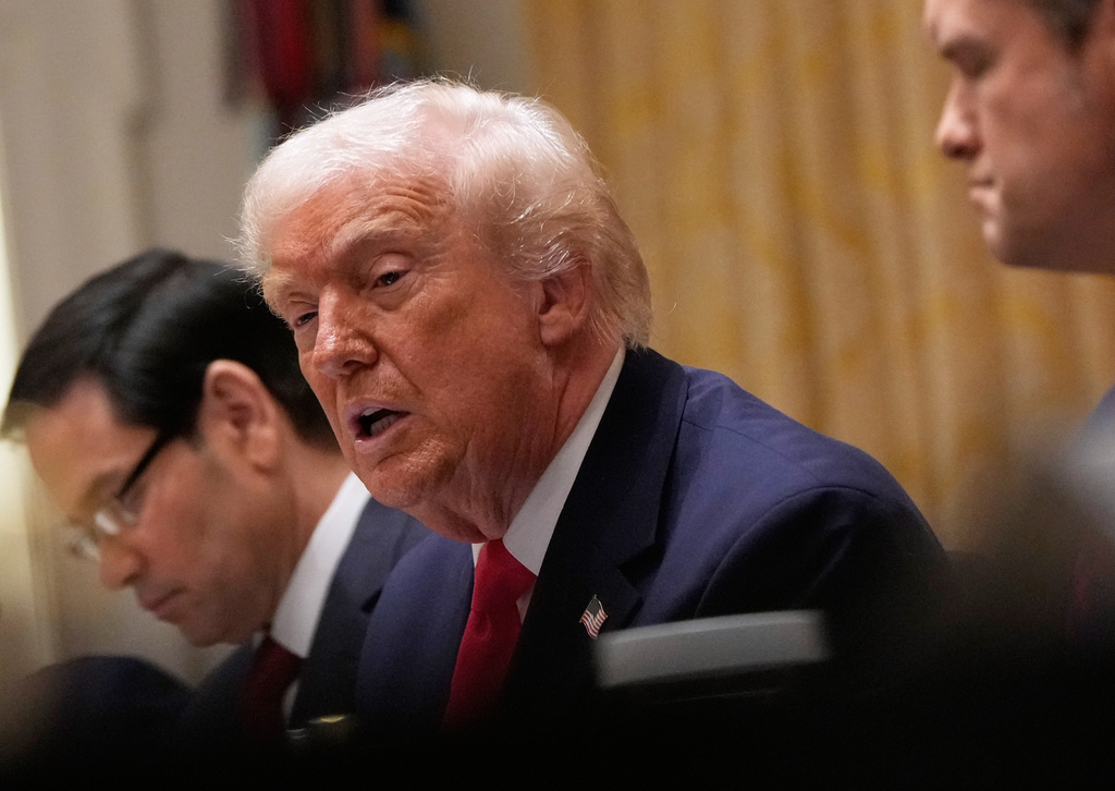 President Donald Trump speaks during a Cabinet meeting at the White House, Tuesday, Dec. 2, 2025, in Washington, with Secretary of State Marco Rubio, seated left and Defense Secretary Pete Hegseth, seated left. (AP Photo/Julia Demaree Nikhinson)