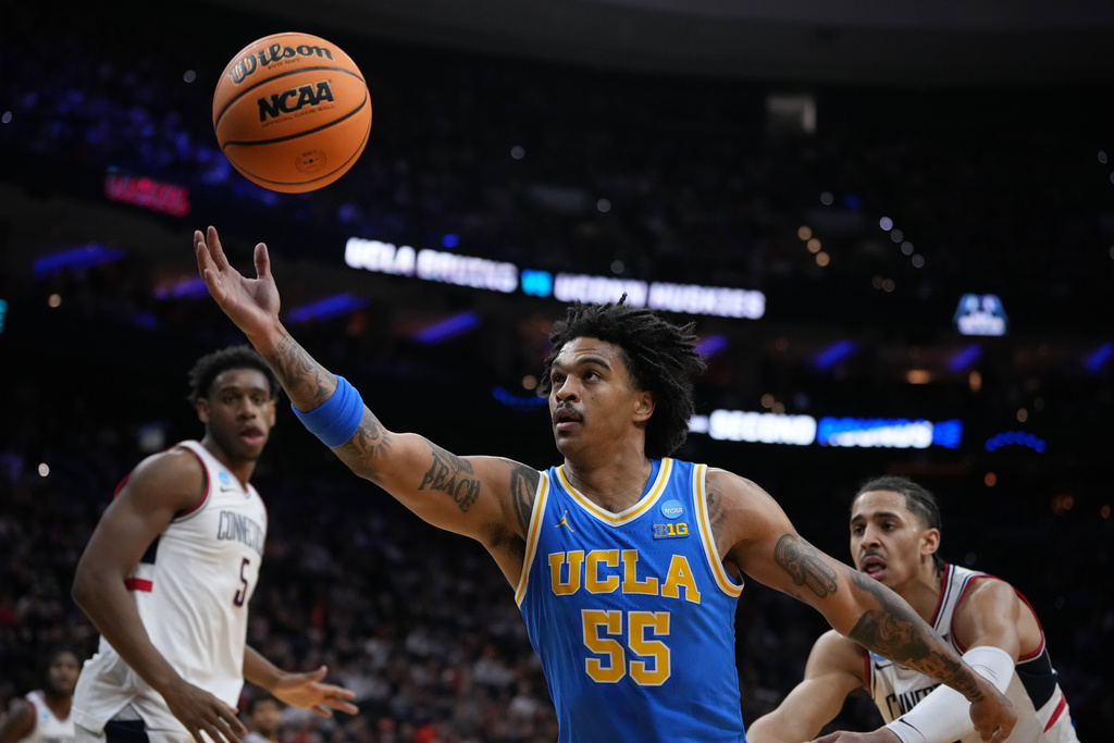 UCLA's Skyy Clark reaches for a loose ball during the first half against UConn in the second round of the NCAA college basketball tournament, Sunday, March 22, 2026, in Philadelphia. (AP Photo/Matt Slocum)