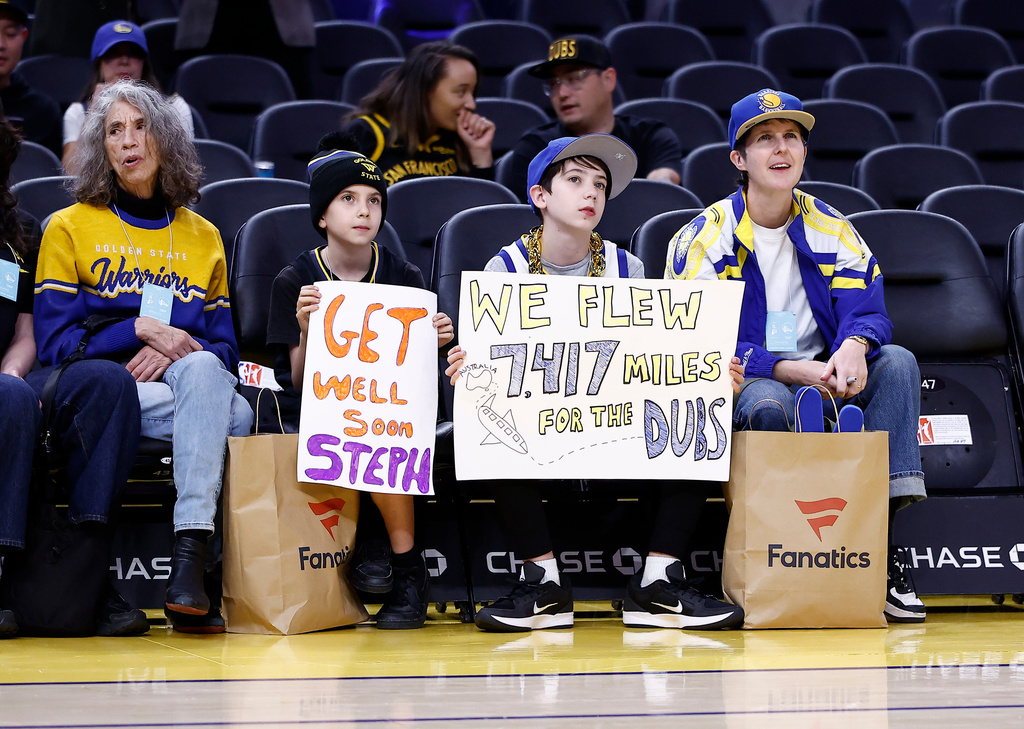 Golden State Warriors fans hold signs during warmups before an NBA basketball game against the Indiana Pacers, Sunday, Nov. 9, 2025, in San Francisco. (AP Photo/Kelley L Cox)
