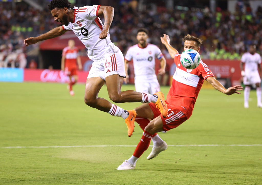 Chicago Fire midfielder Philip Zinckernagel, right, trips Toronto FC midfielder Kosi Thompson, left, during the first half of an MLS soccer match Saturday, Oct. 4, 2025, in Chicago. (AP Photo/Talia Sprague)