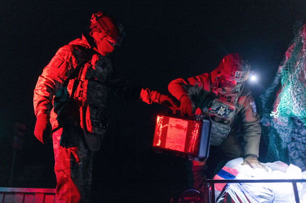 Soldiers from Ukraine's Armed Forces Khartia brigade load ammunition on a combat ground drone bound for the front line in Kharkiv region, Ukraine, Jan. 27, 2026. (AP Photo/Nikoletta Stoyanova)