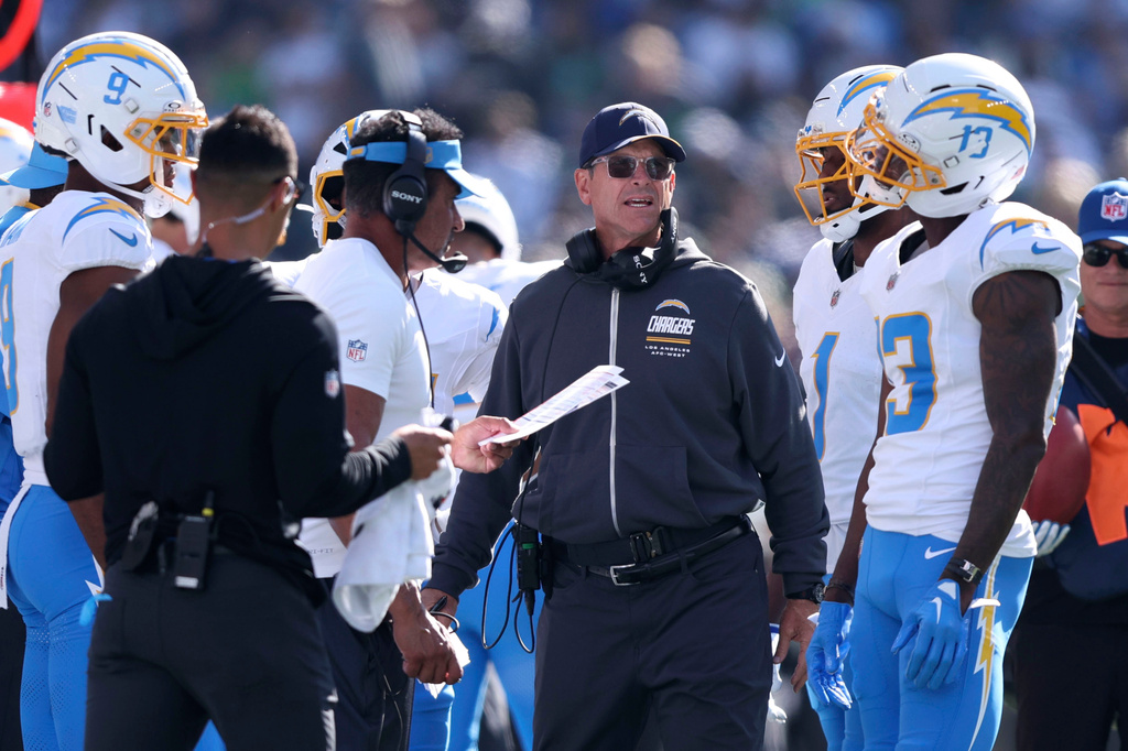 Los Angeles Chargers head coach Jim Harbaugh, center, reacts on the sideline during the first half of an NFL football game against the Seattle Seahawks, Sunday, Oct. 4, 2026, in Seattle. (AP Photo/Kevin Ng)