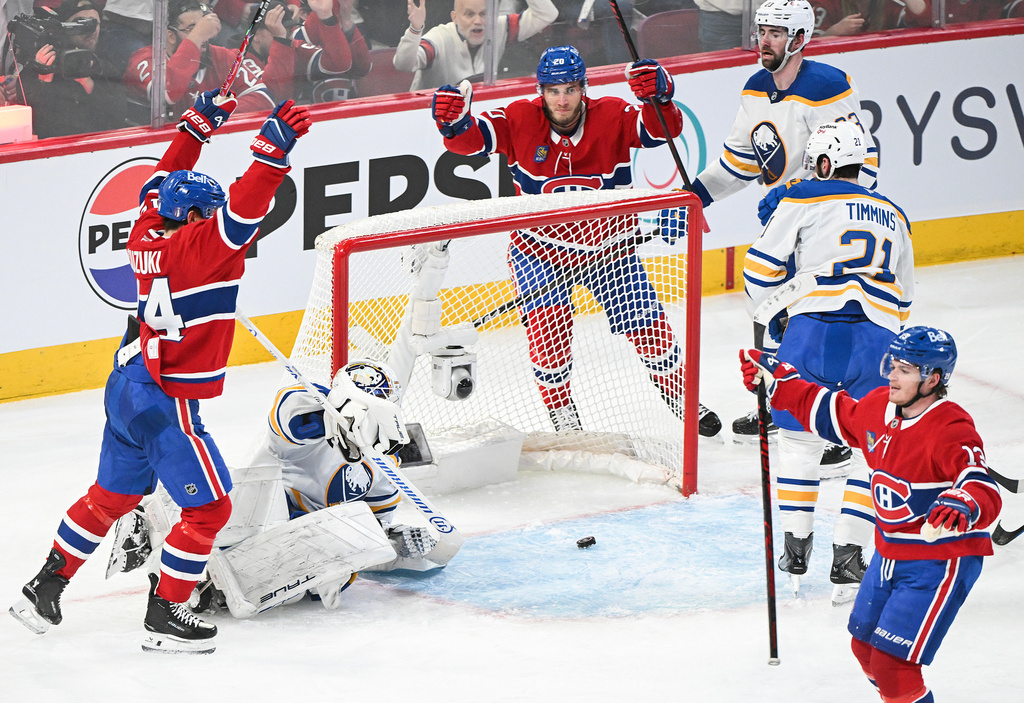 Montreal Canadiens' Cole Caufield (13) reacts after scoring against Buffalo Sabres goaltender Alex Lyon, second from left,during the second period of Game 3 in a second-round NHL hockey Stanley Cup playoff series in Montreal, Sunday, May 10, 2026. (Graham Hughes/The Canadian Press via AP)