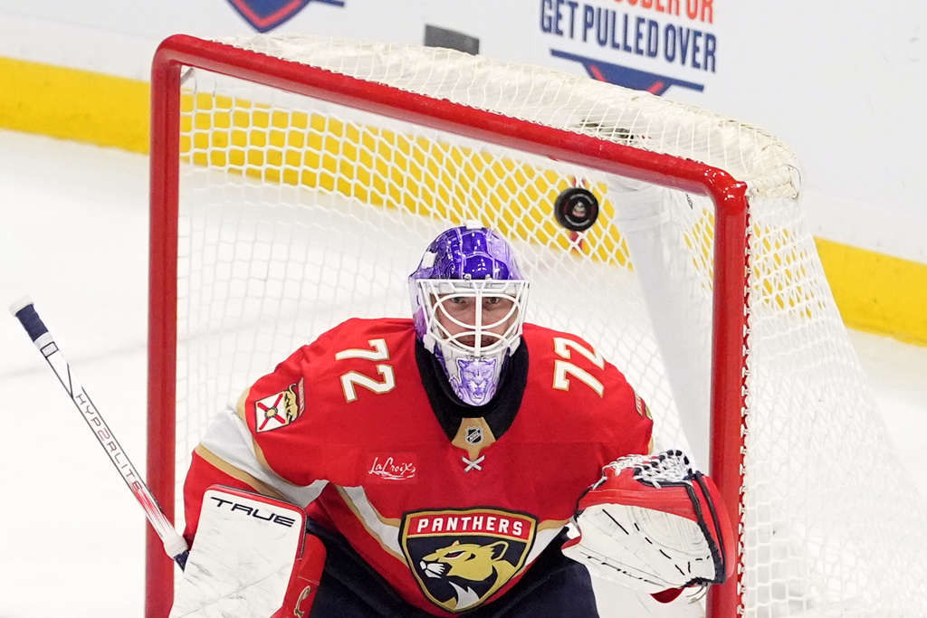 Florida Panthers goaltender Sergei Bobrovsky (72) watches a flying puck during the third period of an NHL hockey game against the New Jersey Devils, Thursday, Nov. 20, 2025, in Sunrise, Fla. (AP Photo/Rebecca Blackwell)