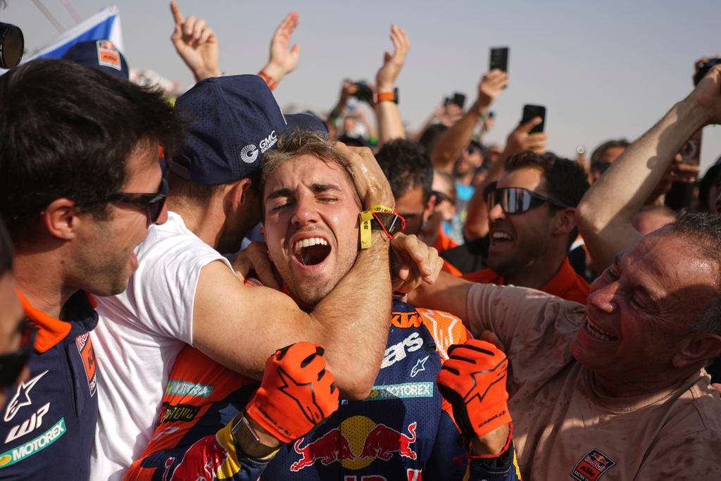 Rider Luciano Benavides of Argentina, centre, celebrates winning the Dakar Rally after the thirteenth stage with a start and finish in Yanbu, Saudi Arabia, Saturday, Jan.17, 2026. (AP Photo/Thibault Camus)