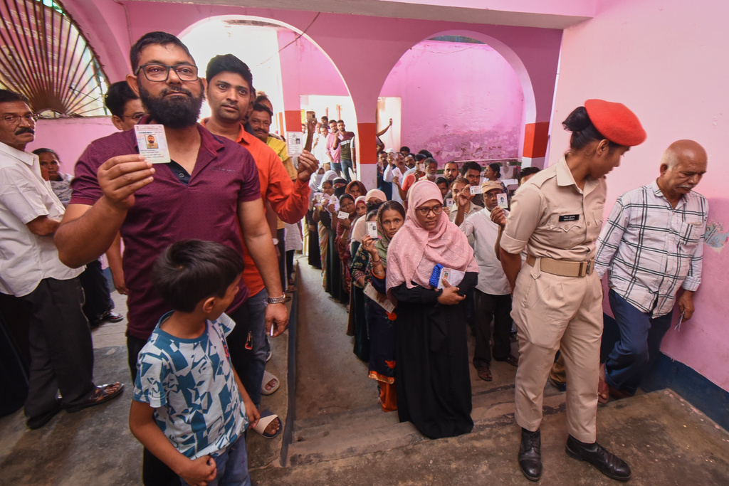 People stand in a queue to cast their votes for Bihar state election at a polling booth in Patna, India, Thursday, Nov. 6, 2025. (AP Photo)