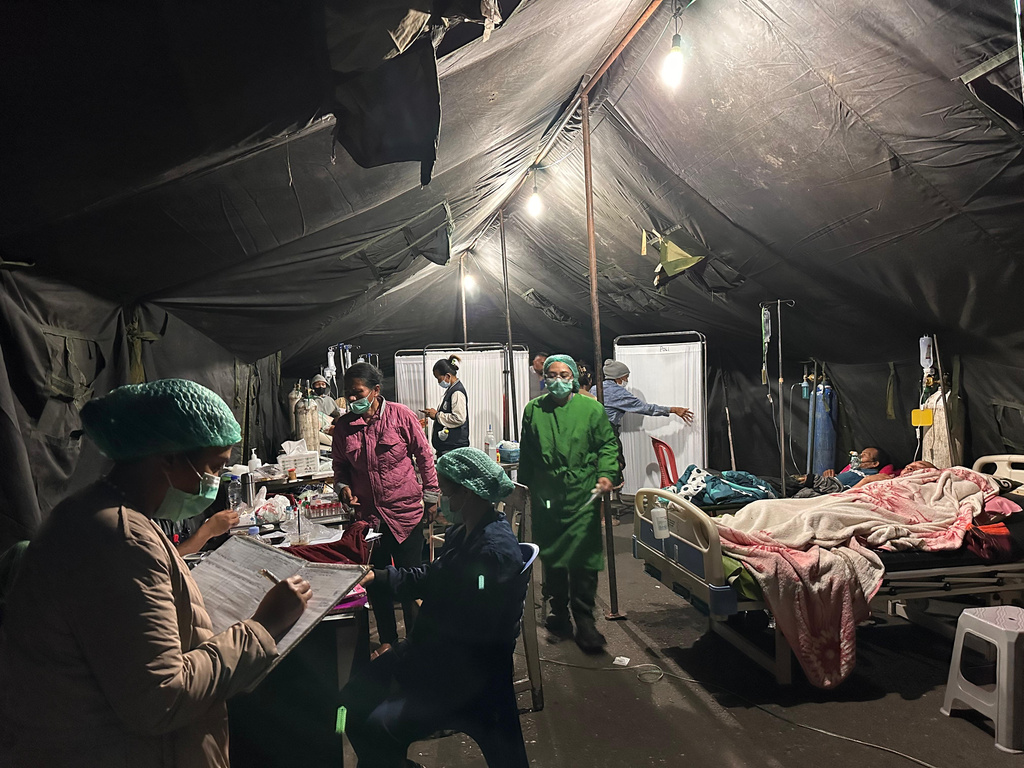 Patients are treated in a makeshift tent outside a hospital, amid fears of aftershocks following an earthquake, in Ruteng, East Nusa Tenggara province, Indonesia, Sunday, Aug. 16, 2026. (AP Photo/Firdia Lisnawati)