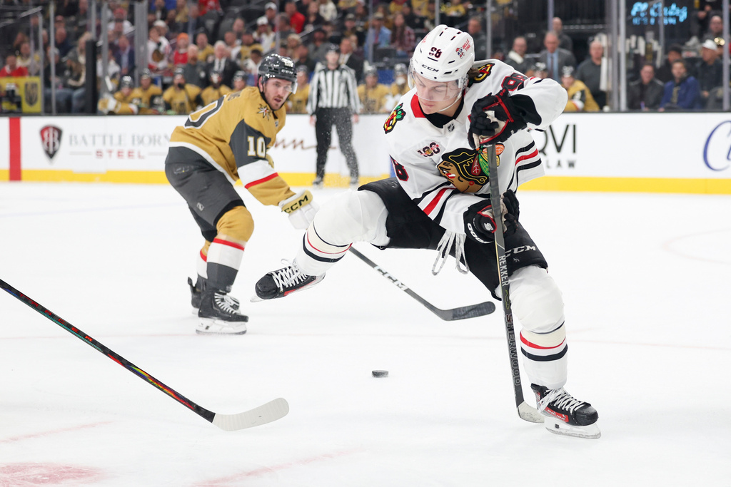 Chicago Blackhawks center Connor Bedard (98) passes the puck against the Vegas Golden Knights during the first period of an NHL hockey game Tuesday, Dec. 2, 2025, in Las Vegas. (AP Photo/Ian Maule)
