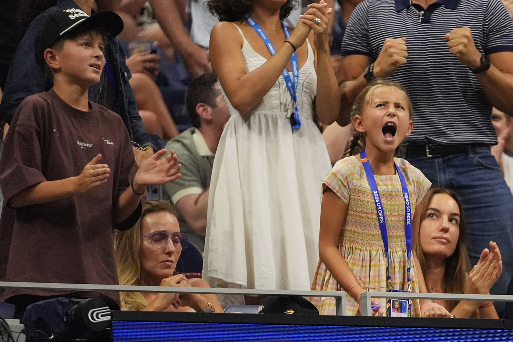 Tara Djokovic, right, reacts with her mom Jelena Djokovic center, and brother Stefan Djokovic, left, as her dad, Novak Djokovic, of Serbia, competes against Mariano Navone, of Argentina, during the first round of the U.S. Open tennis championships Sunday, Aug. 30, 2026, in New York. (AP Photo/Frank Franklin II)
