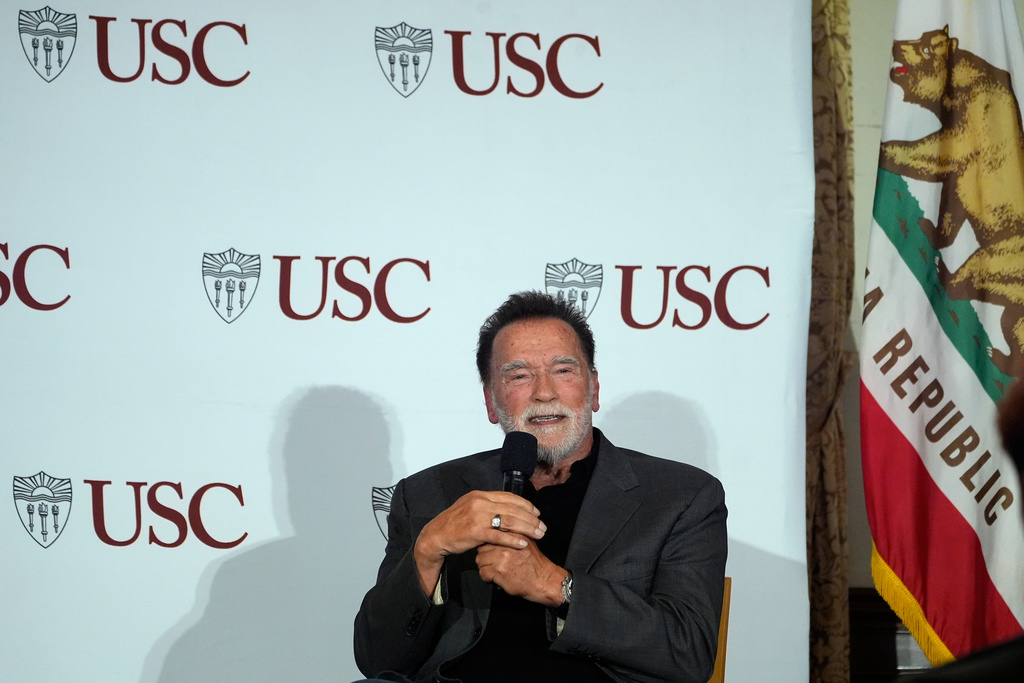 Former California Gov. Arnold Schwarzenegger, right, expresses his opposition to Proposition 50, a California ballot measure to redraw U.S. House maps to boost Democrats, during a conversation with University of Southern California interim president Beong-Soo Kim, not shown, on democracy at the USC campus in Los Angeles, Monday, Sept. 15, 2025 (AP Photo/Damian Dovarganes)