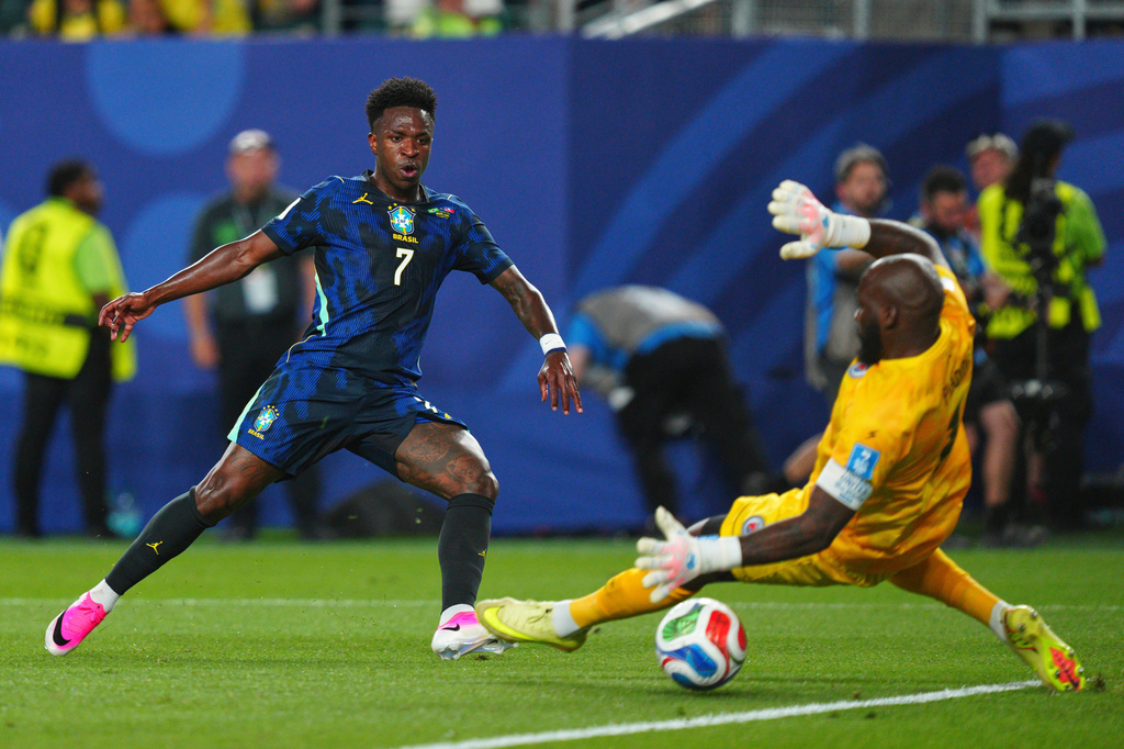 Brazil's Vinicius Junior (7) scores the third goal for his team against Haiti goalkeeper Johny Placide (1) during the World Cup Group C soccer match between Brazil and Haiti in Philadelphia, Friday, June 19, 2026. (AP Photo/Derik Hamilton)
