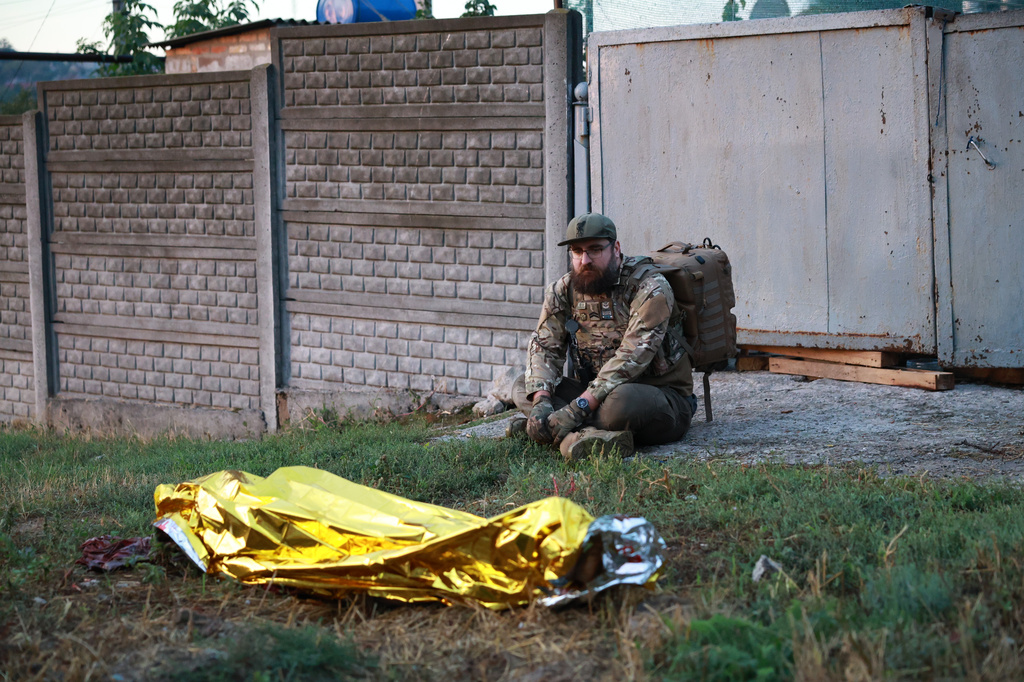 A paramedic looks at the body of a woman killed in a Russian strike on residential neighbourhood on Zaporizhzhia, Ukraine, on Saturday, Sept.26, 2026. (AP Photo/Kateryna Klochko)