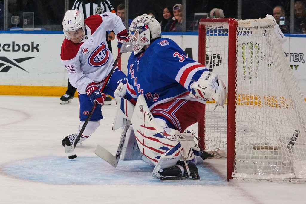 New York Rangers goaltender Igor Shesterkin (31) stops a shot by Montréal Canadiens' Cole Caufield (13) during the first period of an NHL hockey game Thursday, April 2, 2026, in New York. (AP Photo/Frank Franklin II)