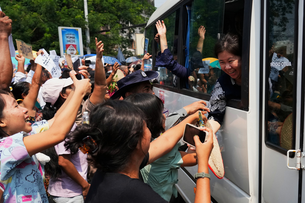 Released prisoners, in a bus, are welcomed by family members and colleagues after they left Insein Prison in Yangon, Myanmar, Friday, April 17, 2026, following Myanmar President's amnesty to mark the country's traditional new year. (AP Photo/Thein Zaw)