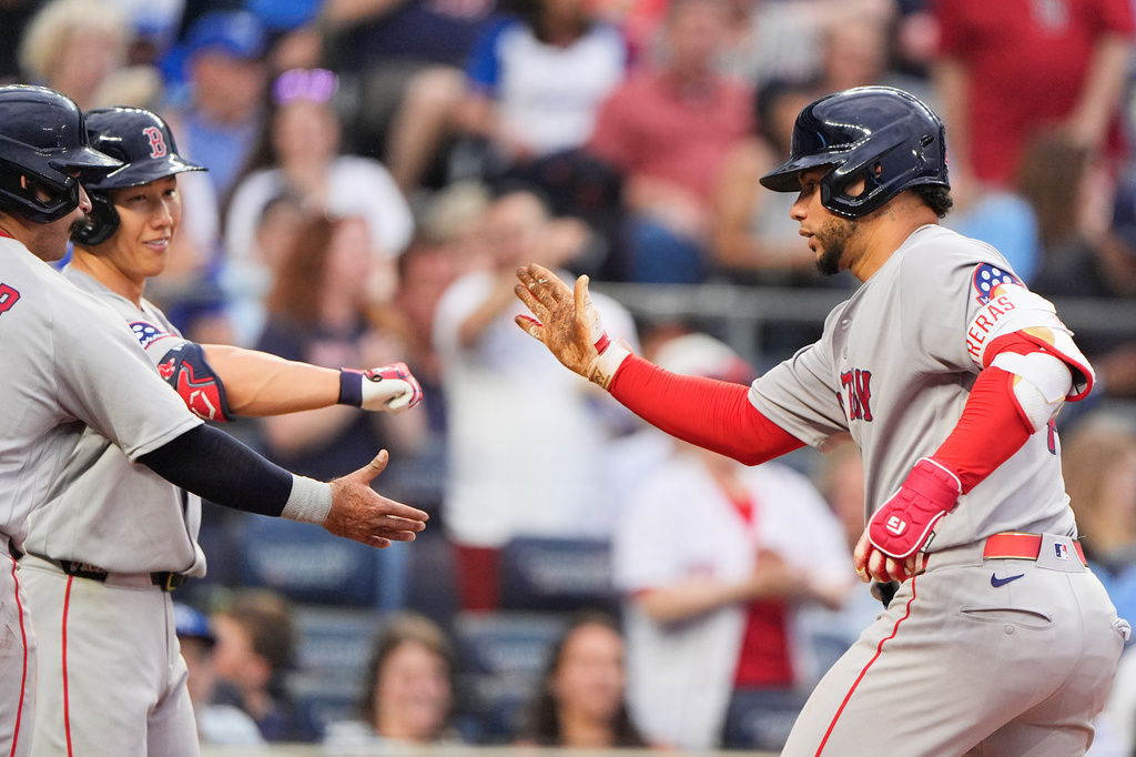 Boston Red Sox's Willson Contreras, right, celebrates with teammates after hitting a two-run home run during the sixth inning of a baseball game against the Kansas City Royals, Monday, May 18, 2026, in Kansas City, Mo. (AP Photo/Charlie Riedel)