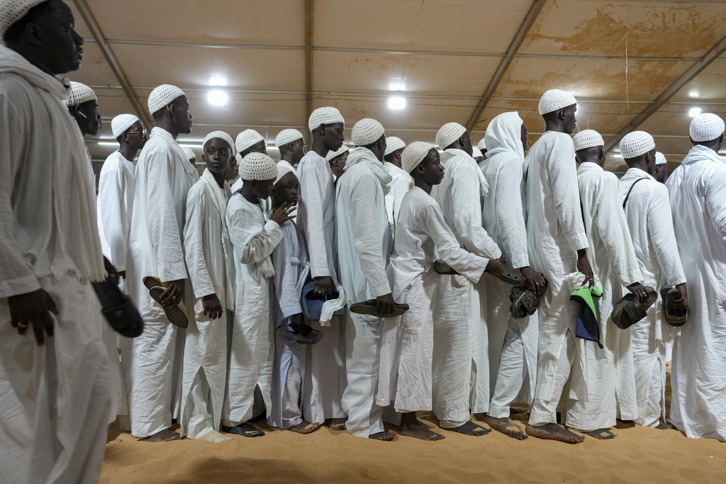 Men and boys in white robes gather for night prayers as they mark Prophet Muhammad's birthday, known as Mawlid, in Dakar, Senegal, Thursday, Sept 4, 2025. (AP Photo/Misper Apawu)