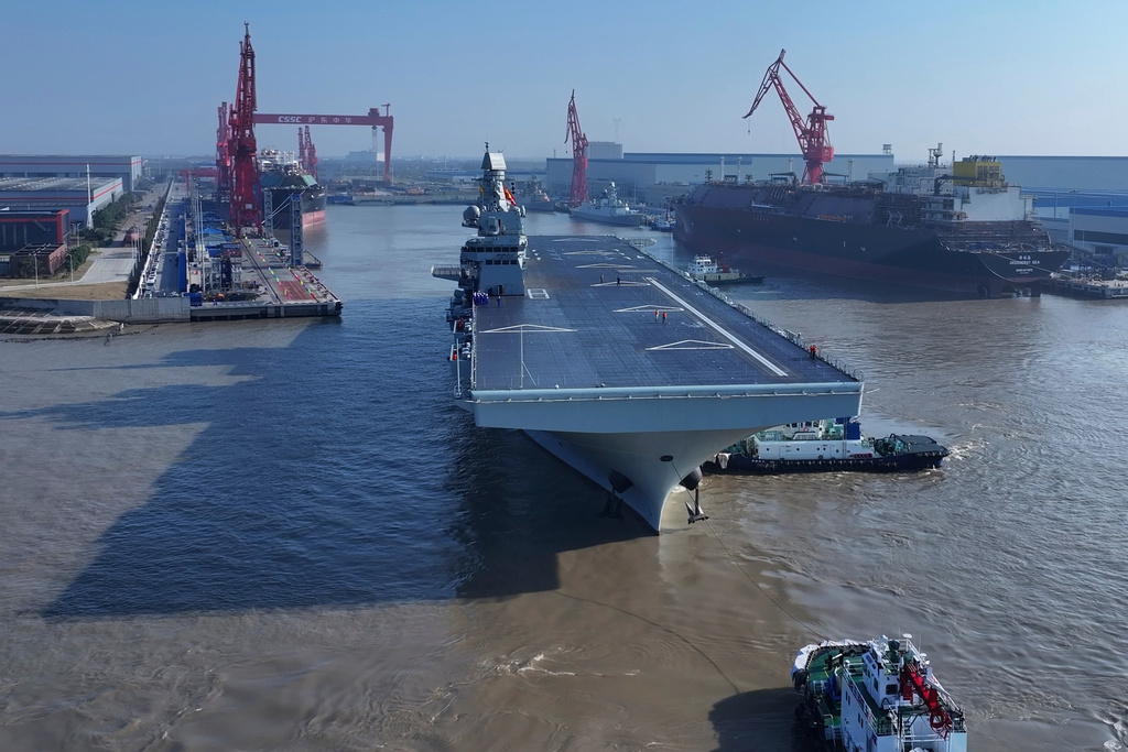 In this photo released by Xinhua News Agency, China's first Type 076 amphibious assault ship, PLANS Sichuan, sets sail from the port of Hudong-Zhonghua Shipbuilding (Group) Co., Ltd. in Shanghai on Friday, Nov. 14, 2025.(Zhang Liang/Xinhua via AP)