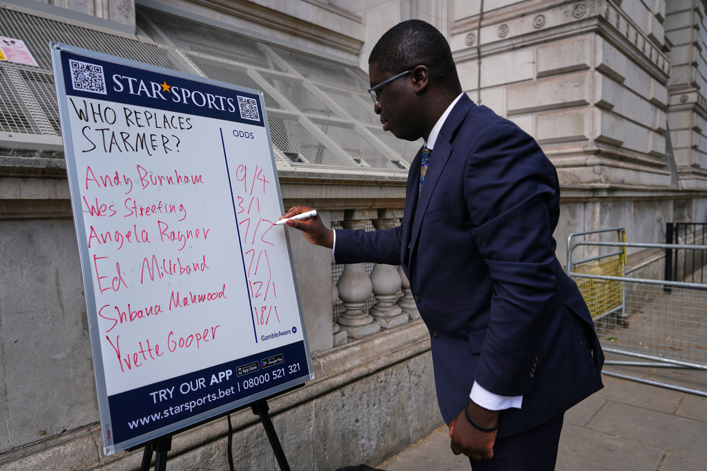 A bookmaker takes bets for a possible next British Prime Minister on his betting board near Downing Street in London, Tuesday, May 12, 2026.(AP Photo/Kirsty Wigglesworth)
