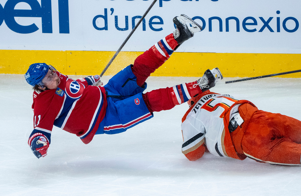 Montreal Canadiens' Brendan Gallagher (11) is tripped by Anaheim Ducks' Olen Zellweger (51) during first-period NHL hockey game action in Montreal, Sunday, March 15, 2026. (Christinne Muschi/The Canadian Press via AP)