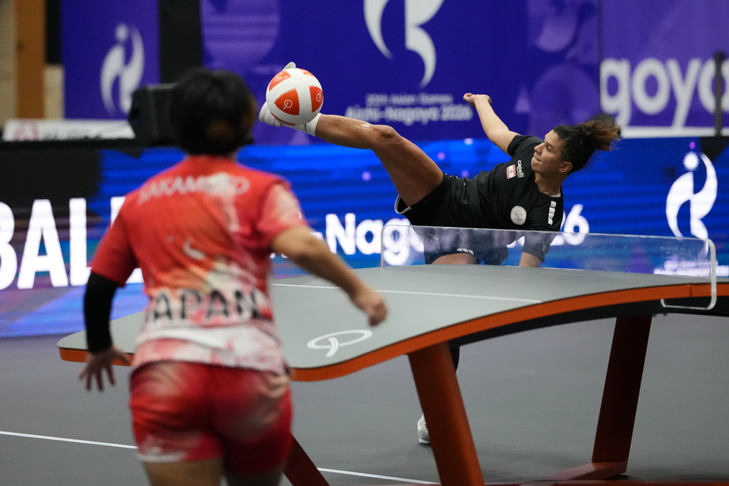 Lebanon's Dandal Kamar, right, kicks the ball against Japan's Yuina Sakamoto during their Teqball quarterfinals match in Nagoya, Japan, Friday, Sept. 18, 2026. (AP Photo/Aaron Favila)