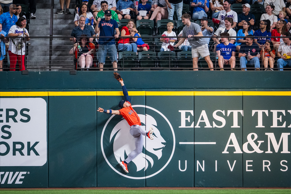 Houston Astros' right fielder Cam Smith catches a ball hit by Texas Rangers' Brandon Nimmo during first inning of a baseball game, Thursday, May 28, 2026, Arlington, Texas. (AP Photo/Jessica Tobias)