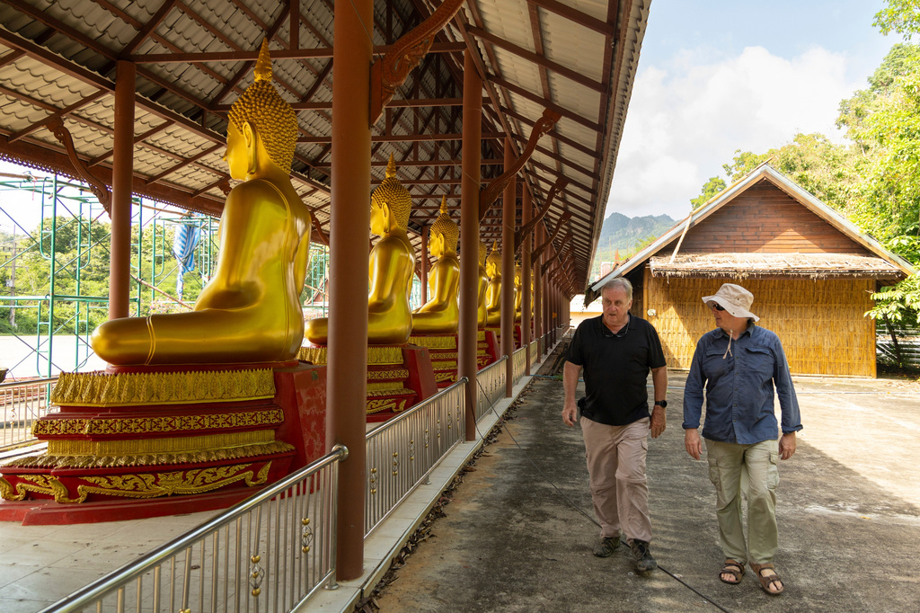 Researchers Andrew Snow, left, and Martyn Fryer visit the Buddhist temple of Wat Tha Khanun, which preserves a section of the infamous World War II "Death Railway," in Thong Pha Phum, Thailand, on Saturday, May 30, 2026. (AP Photo/Anton L. Delgado)