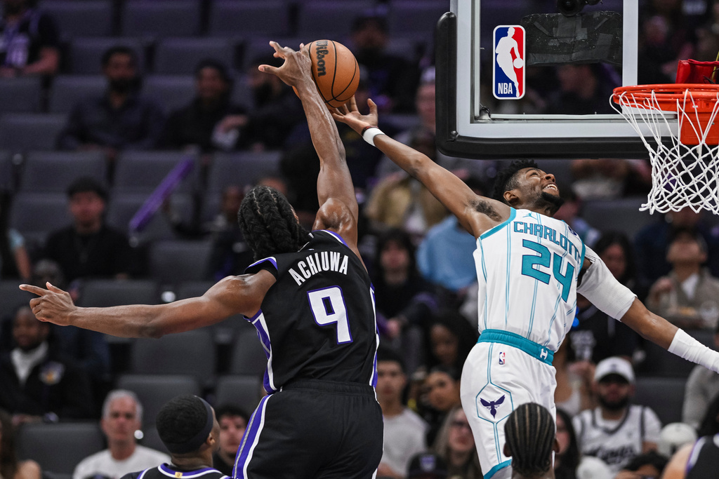 Sacramento Kings forward Precious Achiuwa (9) blocks Charlotte Hornets forward Brandon Miller (24) during the first half of an NBA basketball game, Wednesday, Mar. 11, 2026, in Sacramento, Calif. (AP Photo/Justine Willard)