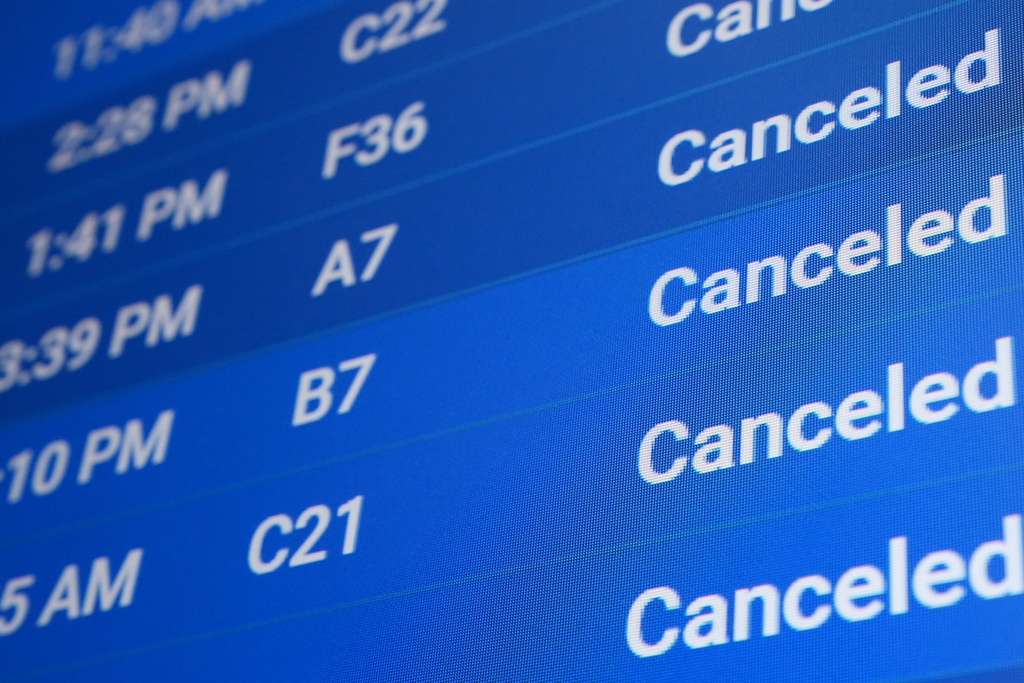 A flight status screen shows canceled flights at Philadelphia International Airport during a winter storm in Philadelphia, Sunday, Jan. 25, 2026. (AP Photo/Matt Rourke)