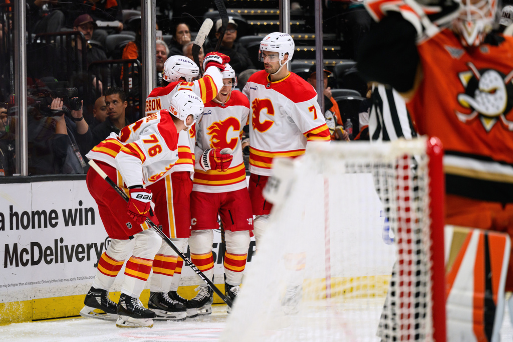 Calgary Flames center Ryan Strome, third from left, is greeted by teammates after scoring during the second period of an NHL hockey game against the Anaheim Ducks, Saturday, April 4, 2026, in Anaheim, Calif. (AP Photo/William Liang)