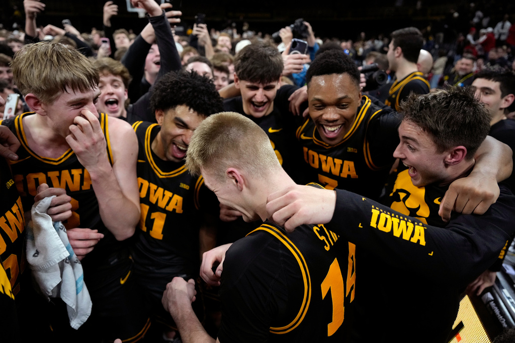 Iowa guard Bennett Stirtz (14) celebrates with teammates after an NCAA college basketball game against Nebraska, Tuesday, Feb. 17, 2026, in Iowa City, Iowa. (AP Photo/Charlie Neibergall)