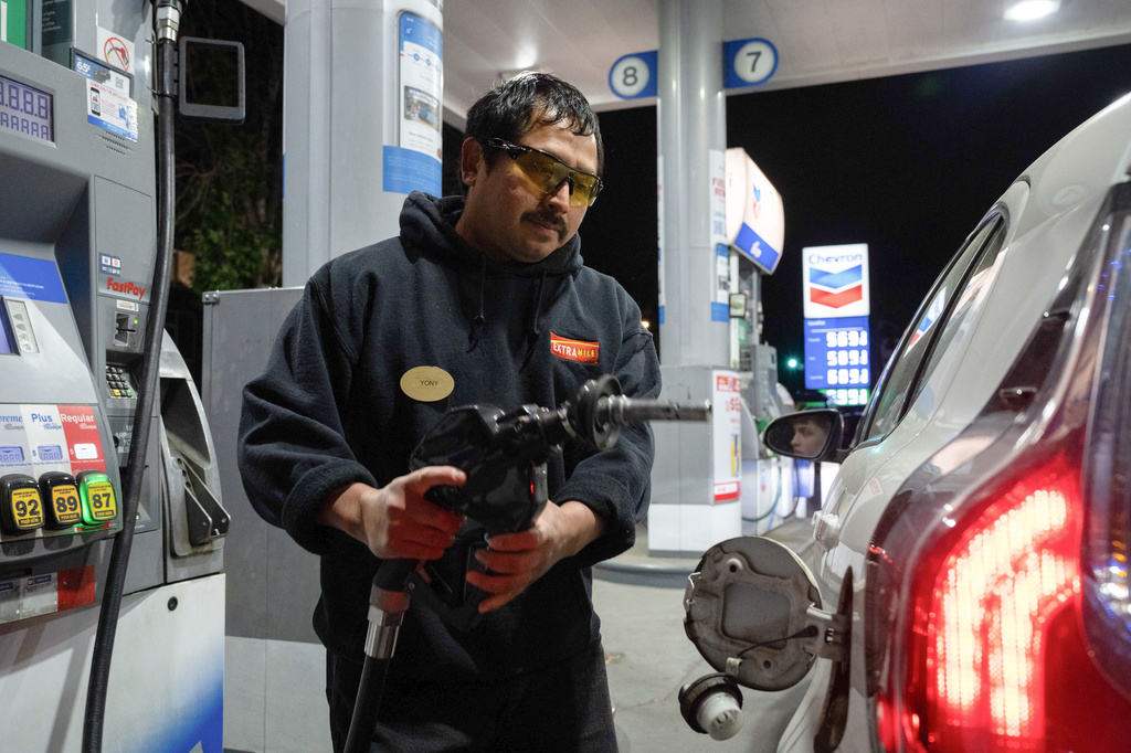 An attendant prepares to fill a customers tank at a gas station on Wednesday, May 6, 2026, in Portland, Ore. (AP Photo/Jenny Kane)