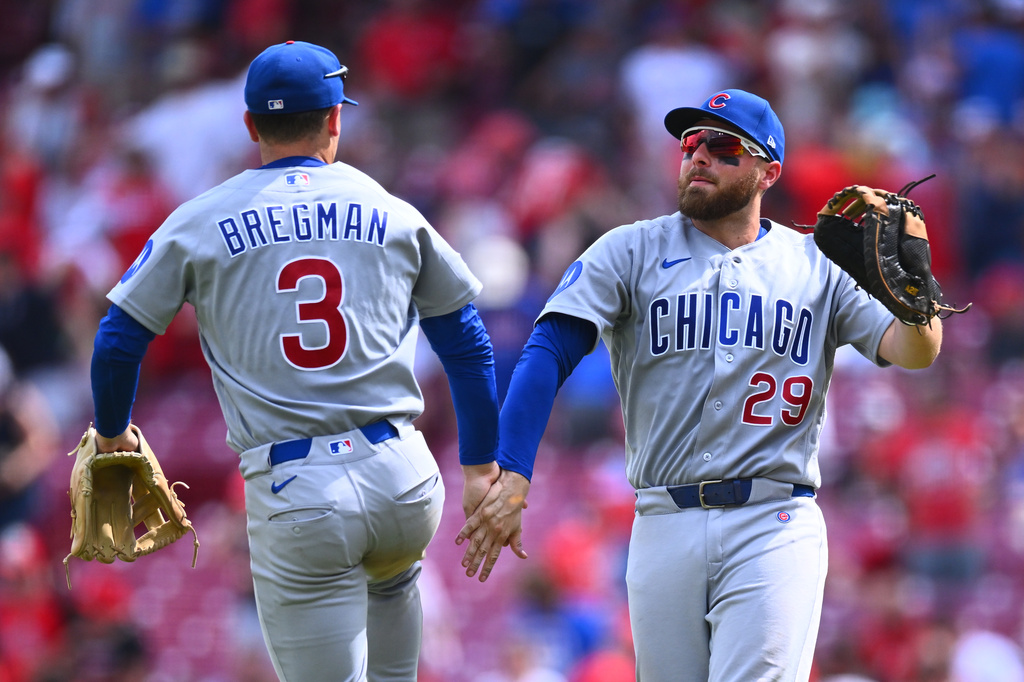 Chicago Cubs' Alex Bregman, left, and Michael Busch celebrate following a baseball game against the Cincinnati Reds in Cincinnati, Sunday, July 12, 2026. (AP Photo/Ben Jackson)