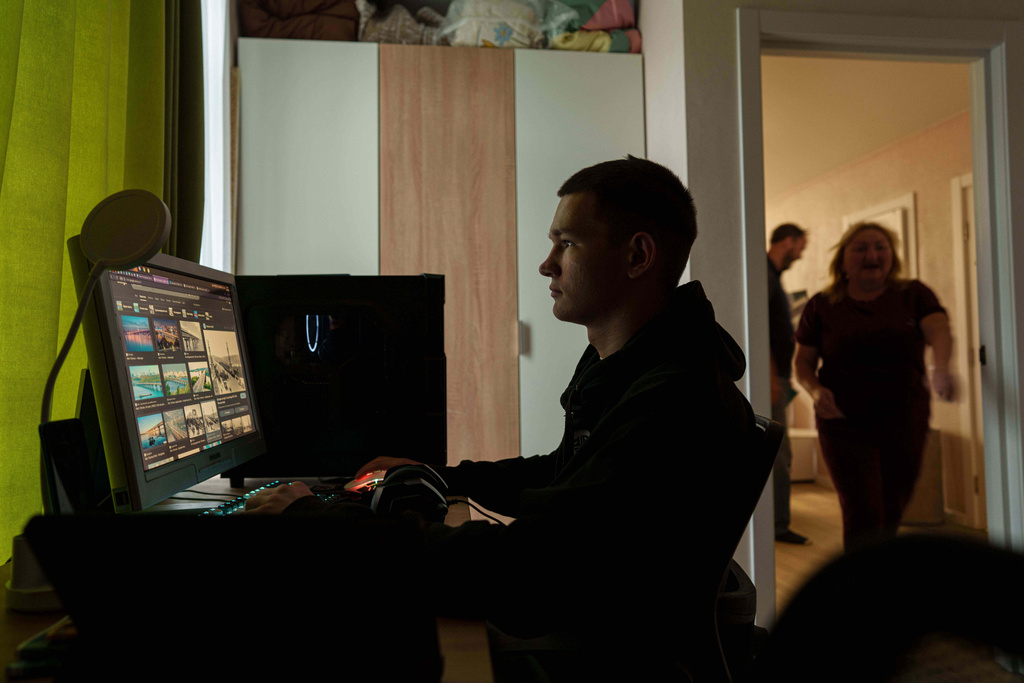 Mykyta Bogomol, 16, works on a computer at the Hansen Village complex where he lives in foster care in Tarasivka, Ukraine, Thursday, Oct. 2, 2025. (AP Photo/Evgeniy Maloletka)