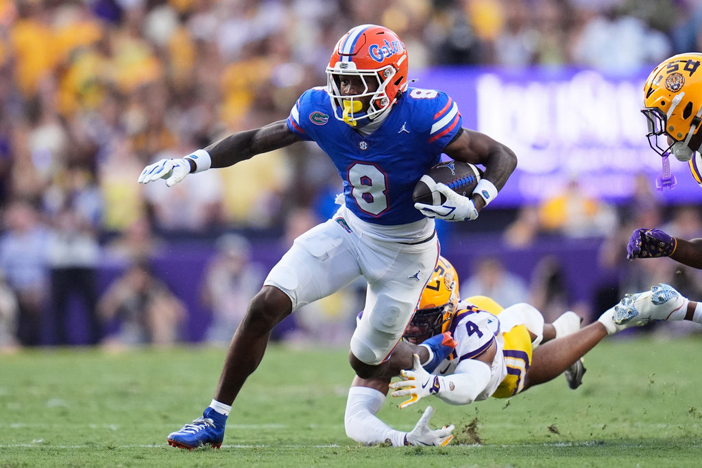 FILE - Florida wide receiver Vernell Brown III (8) carries against LSU cornerback Mansoor Delane (4) in the first half of an NCAA college football game, Sept. 13, 2025, in Baton Rouge, La. (AP Photo/Gerald Herbert, File)