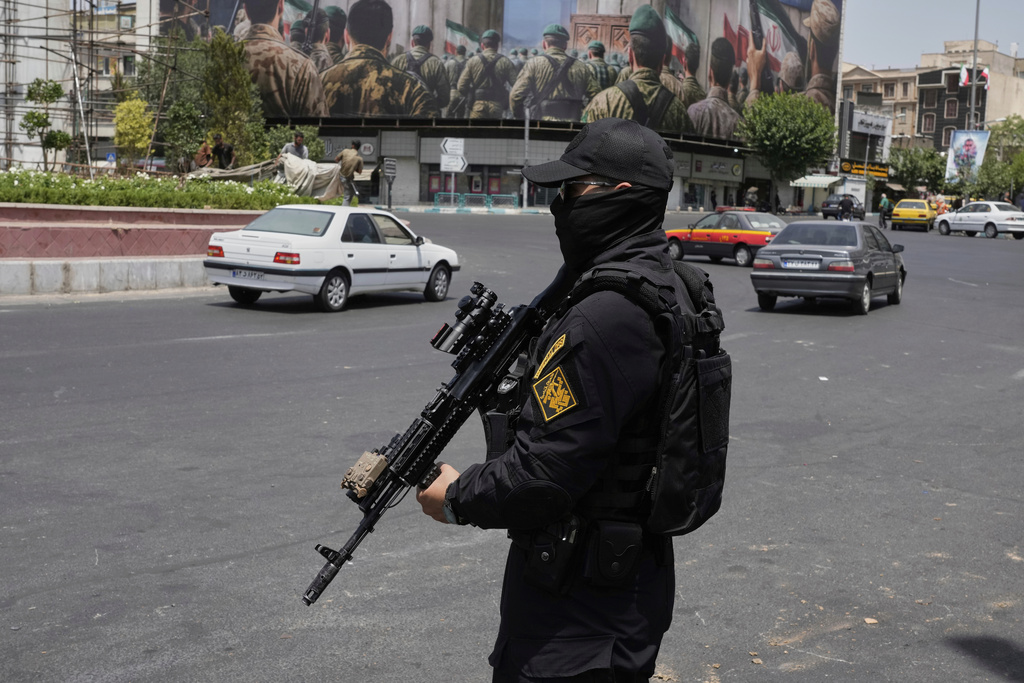 FILE - A member of Iran's Revolutionary Guard stands guard at Enqelab-e-Eslami (Islamic Revolution) square in downtown Tehran, Iran, Tuesday, June 24, 2025. (AP Photo/Vahid Salemi, File)