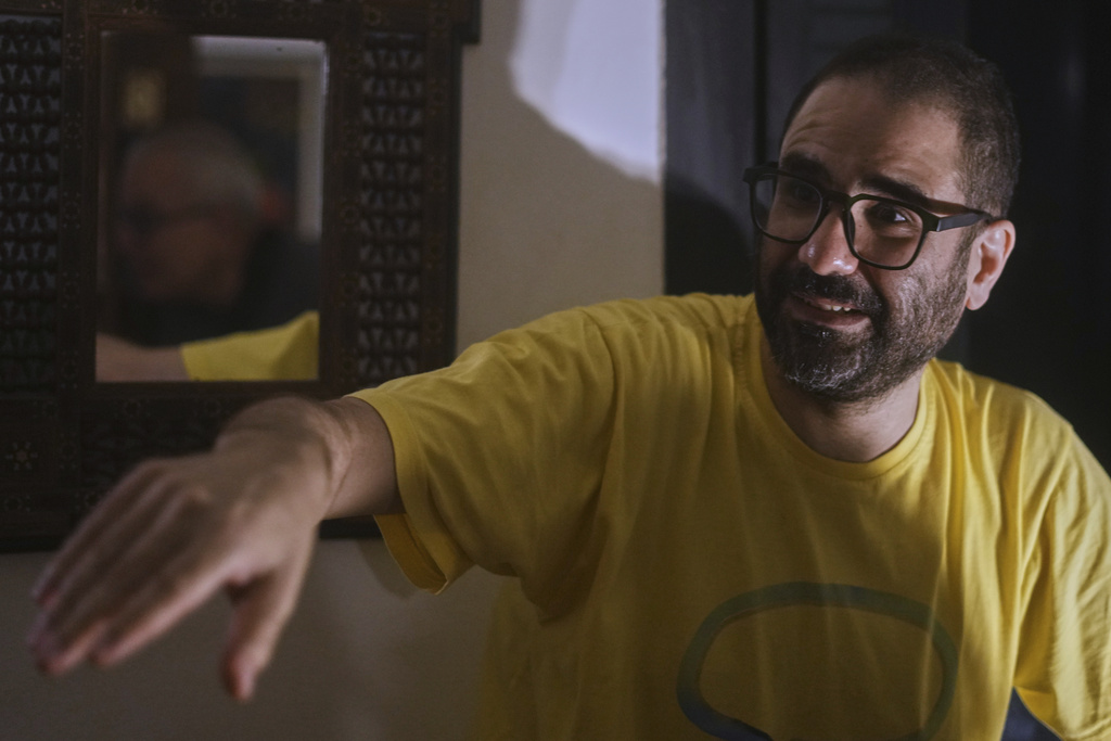 Pro-democracy Egyptian-British activist Alaa Abd el-Fattah, who was in prison for almost all of the past 12 years, speaks to his family as he arrives at his home, after a presidential pardon, in Cairo, Egypt, Tuesday, Sept. 23, 2025. (AP Photo/Amr Nabil)