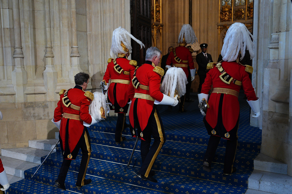 Members of the King's Body Guards of the Honourable Corps of Gentlemen at Arms arrive at the Sovereign's Entrance for the State Opening of Parliament in the House of Lords, in London, Wednesday May 13, 2026. (Aaron Chown/Pool Photo via AP)